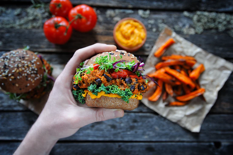 Plant based burger being held