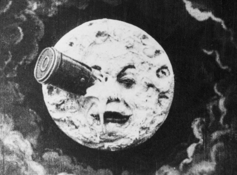 A black and white drawing of a rocket crashed into a fanciful face in the moon.