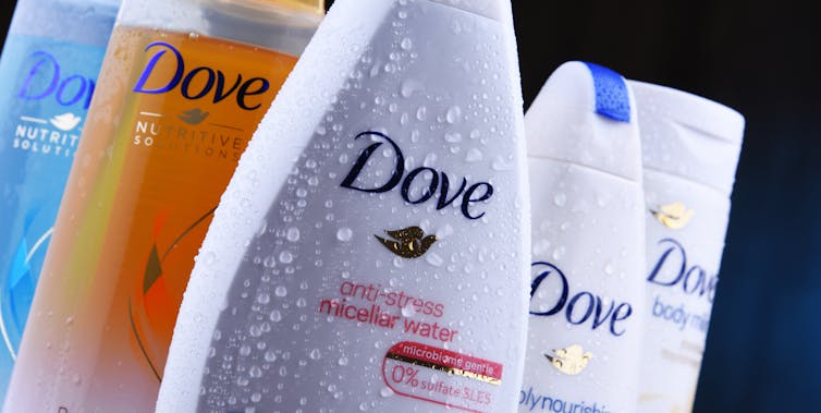 Several bottle of Dove branded soap.