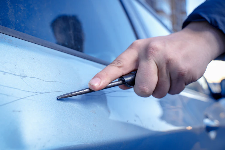 Man scratching car