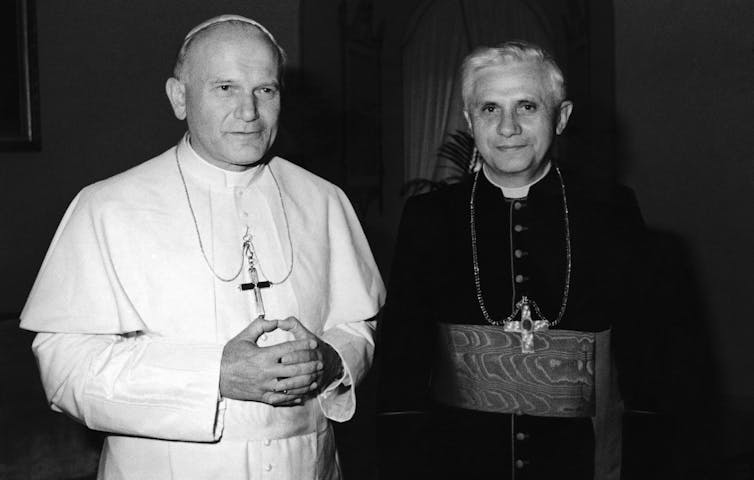 Pope John Paul II stands beside Cardinal Joseph Ratzinger.