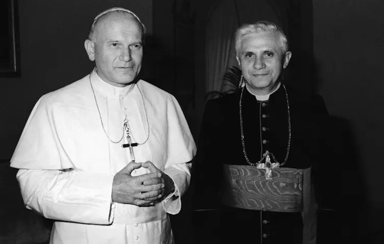 Pope John Paul II stands beside Cardinal Joseph Ratzinger.