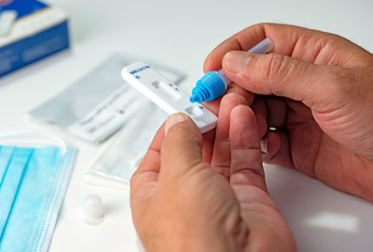Person using a rapid antigen test for COVID