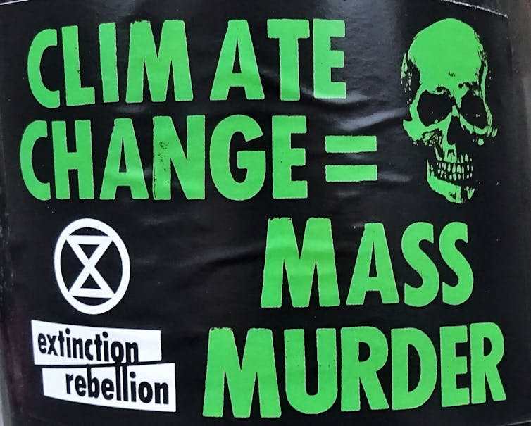 An Extinction Rebellion poster reading 'Climate change = Mass murder'