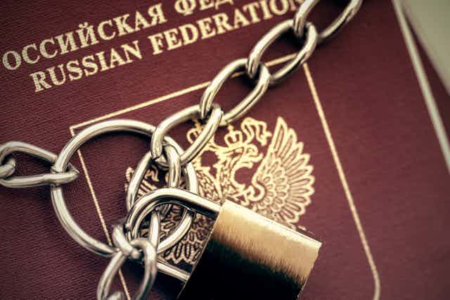 A Russian passport with a padlock and chain.