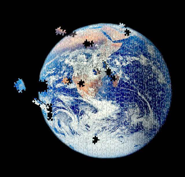 An image of Earth as a jigsaw puzzle with pieces floating into place.