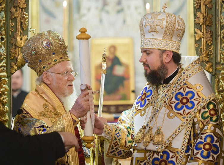 Two leaders of the Orthodox Church, dressed in religious attire, in the new Orthodox Church of Ukraine.