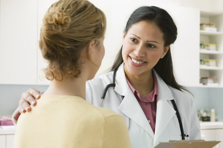 A Latina physician talks to her patient.