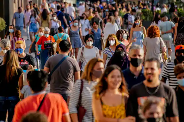 People wearing masks walking in the street