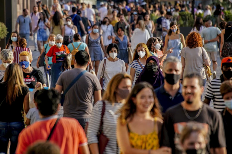People wearing masks walking in the street