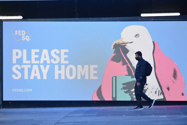 A sign at Federation Square saying 'please stay home'