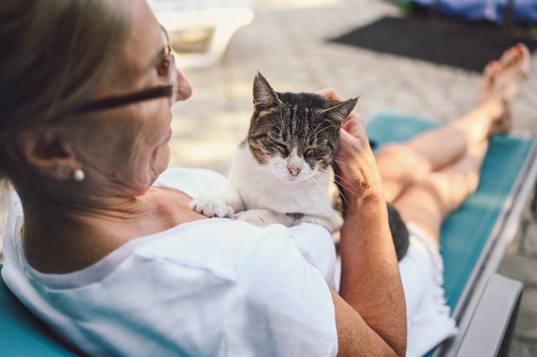 Woman holding a cat.