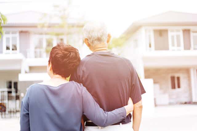 Older couple looking at a house.
