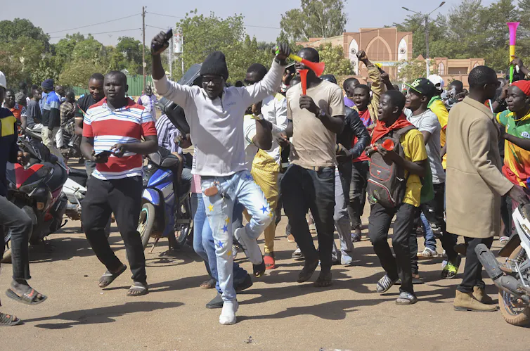 A group of men dance on the streets of Ouagadougou, Burkina Faso.