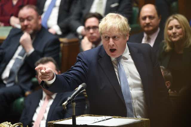 Boris Johnson pointing a finger across the aisle as he speaks in the House of Commons. 