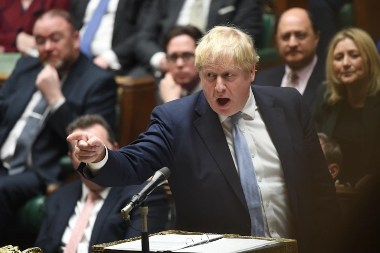 Boris Johnson pointing a finger across the aisle as he speaks in the House of Commons.