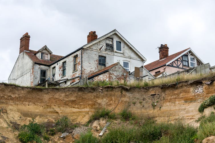 A house on a clifftop viewed from below