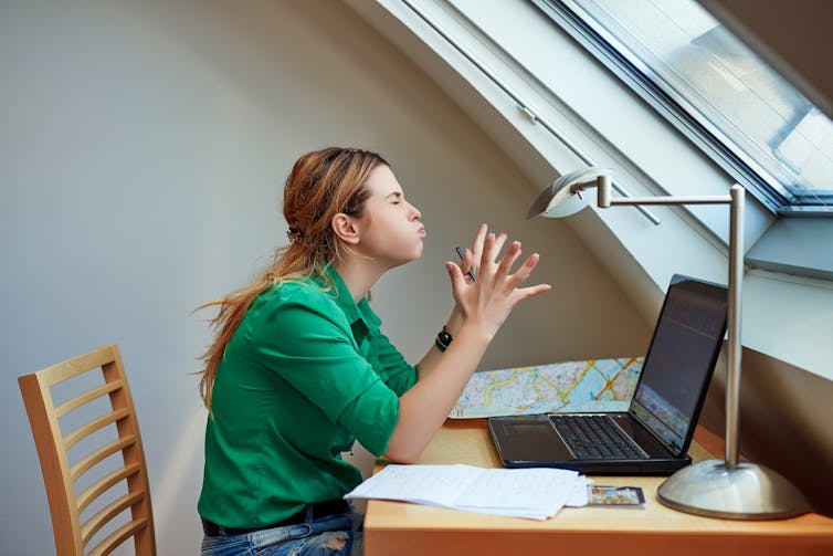 A woman gets frustrated at her laptop.