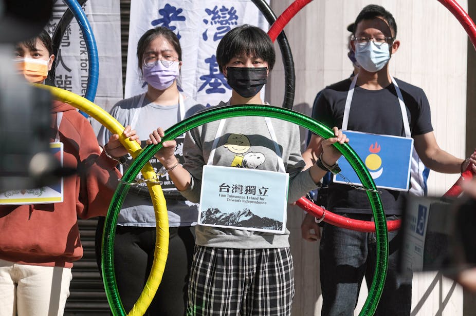 Activists holding signs and Olympic Rings calling for the "Boycott of Beijing Olympics" in front of the Legislative chamber in Taipei, Taiwan.