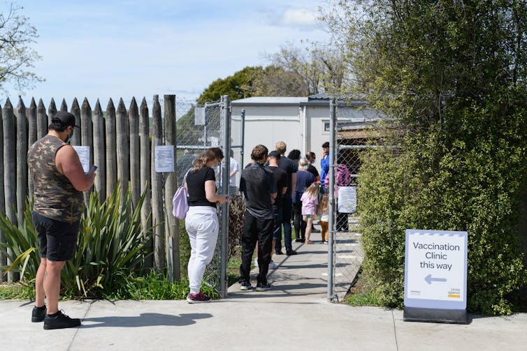 Queue of people waiting outside a vaccination centre.