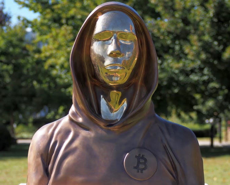 Bust with gold face wearing a hooded sweatshirt.