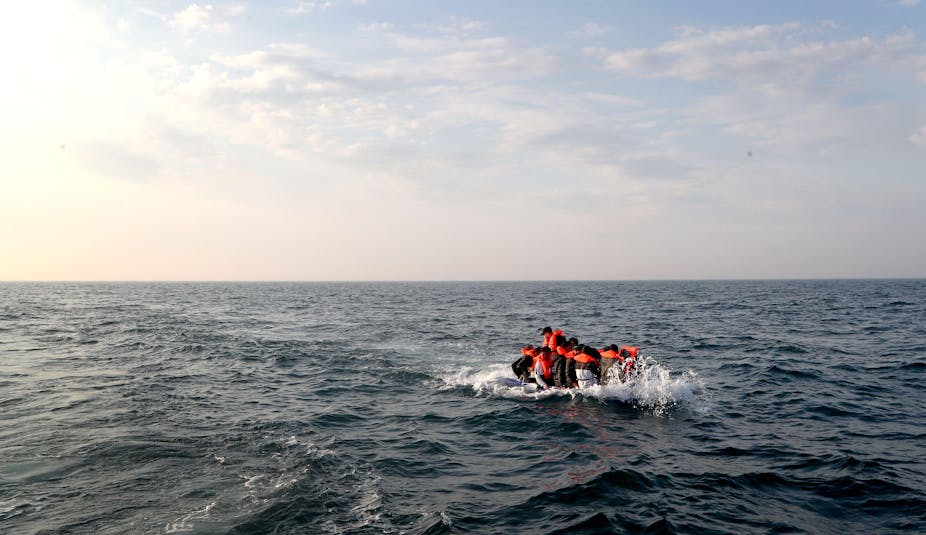 A group of migrants crossing the Channel in a small boat headed in the direction of Dover, Kent.