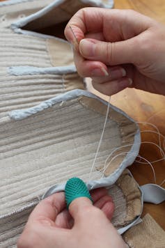 Two hands sewing