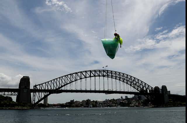 An iceberg and a dancer suspended above Sydney Harbour