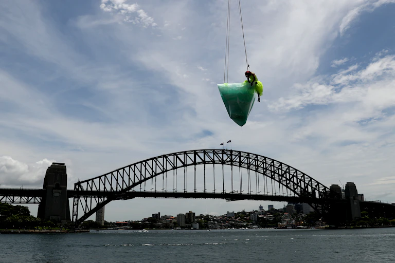 An iceberg and a dancer suspended above Sydney Harbour