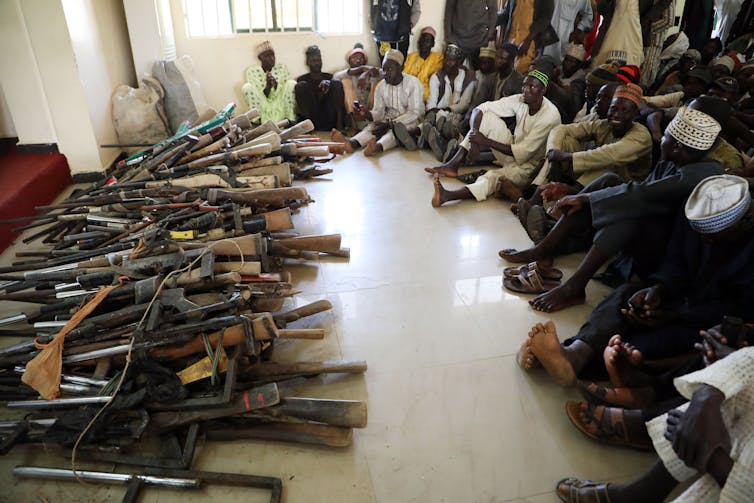 A stash of Kalashnikovs and locally made hunting rifles surrendered by a local vigilante group in Zamfara State, northwest Nigeria. Photo by Kola Sulaimon/AFP via Getty Images