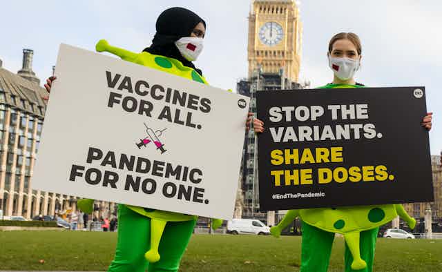 Campaigners outside of the UK parliament asking for vaccines to be shared worldwide