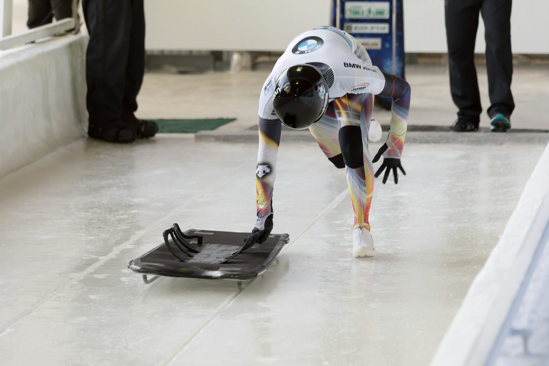 A skeleton racer running with his sled at the start of a race.