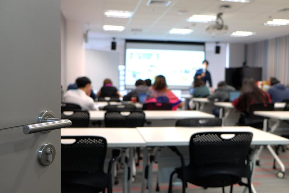 Image of a blurry instructor seen from the doorway.