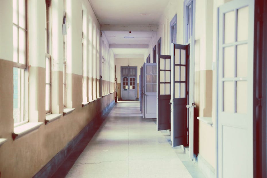 An empty hallway of open doors.