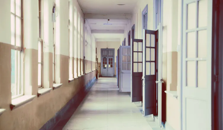 An empty hallway of open doors.