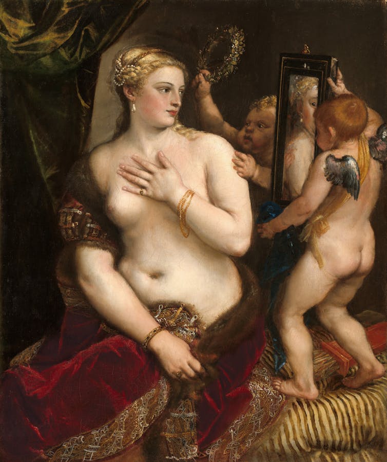 A naked Venus looks in a mirror held up by cherubs