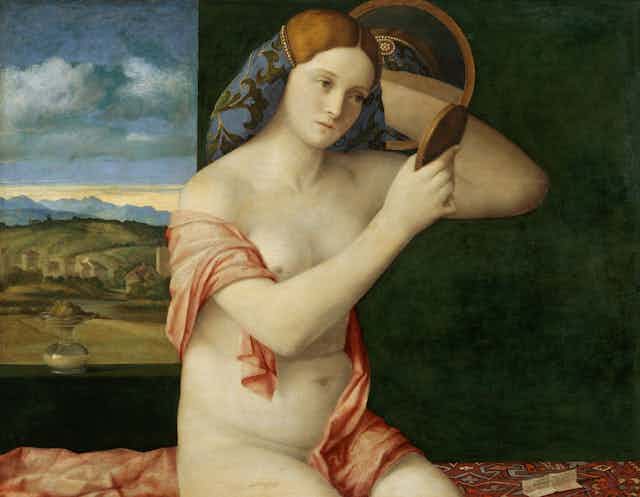 A Renaissance painting of a naked woman looking in a mirror