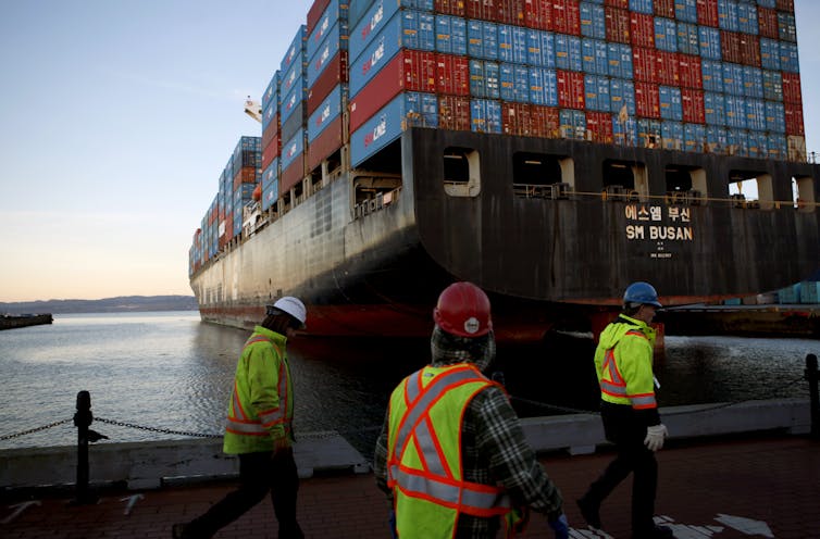 cargo ship and dock workers at port