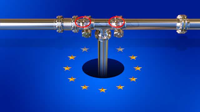 A metal pipeline descends into a hole within the EU flag.