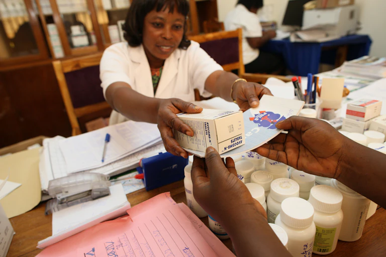 A medic handing over medicine to HIV patient