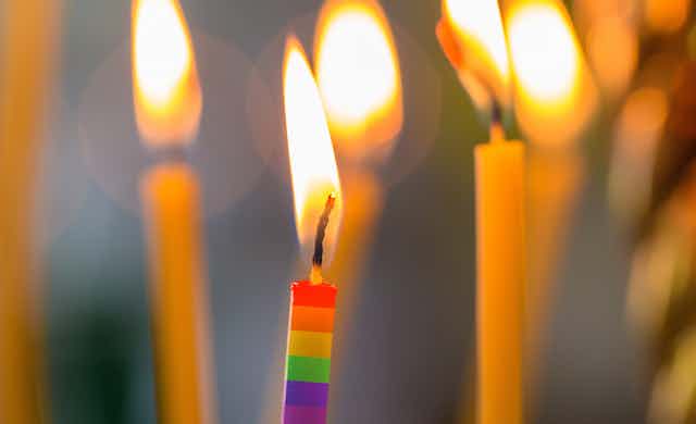 a lit rainbow candle