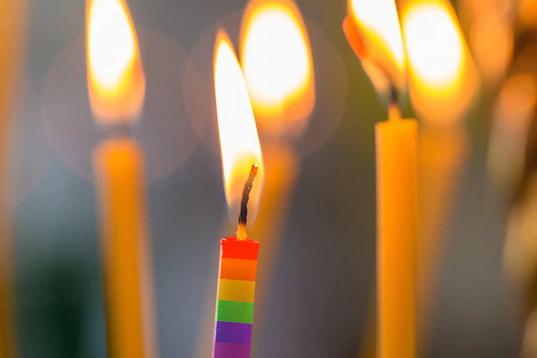 a lit rainbow candle