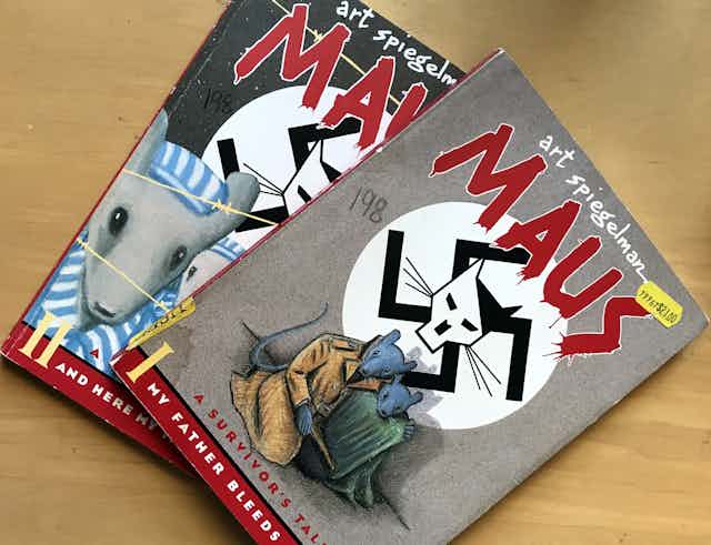 The front covers of two graphic novels showing illustrations of mice in internment uniforms and mice in traveling clothing, against the backdrop of a stylized swastika showing a cat face 