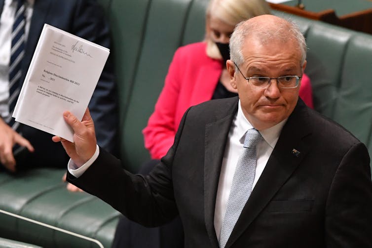 Scott Morrison holding a copy of the religious discrimination bill.