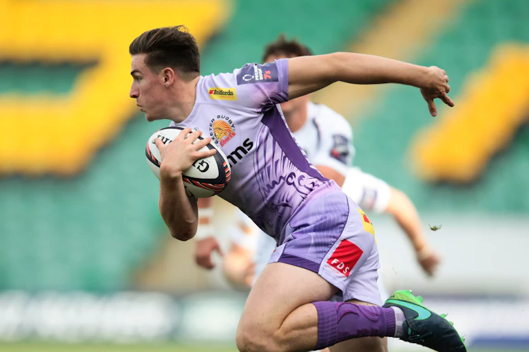 Jordan Bond running with rugby ball