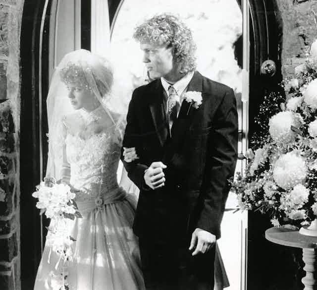 Craig McLachlan as Henry giving away Kylie Minogue as Charlene on her wedding day in Neighbours
