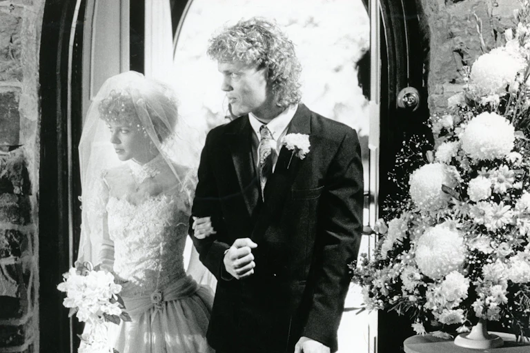 Craig McLachlan as Henry giving away Kylie Minogue as Charlene on her wedding day in Neighbours
