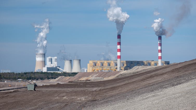 A power plant with chimneys emitting smoke