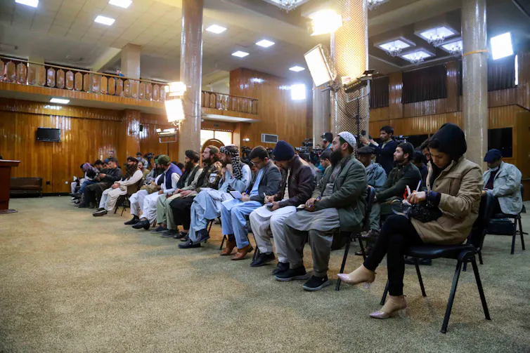 A group of seated Afghanistan journalists at a press conference in Kabul.