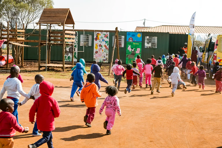 Preschool kids playing in the playground of a creche.